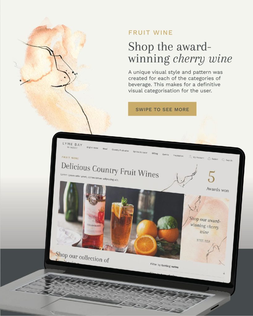 A laptop at an angle on a table, displays a website for Lyme Bay Winery’s fruit wines, featuring images of bottled drinks and citrus fruits. The background includes abstract watercolour art and text promoting award winning cherry wine.